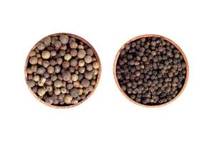 allspice in a wooden bowl. Black pepper. isolated on white background. photo