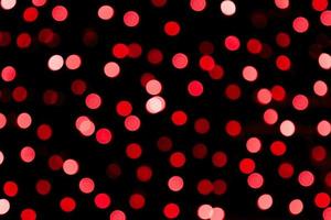 Unfocused abstract red bokeh on black background. defocused and blurred many round light photo