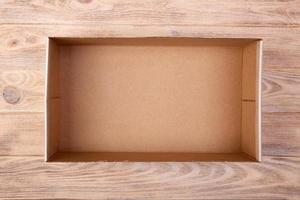 Cardboard box on a white wooden background. top view photo