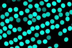 Unfocused abstract colourful bokeh black background. defocused and blurred many round blue light photo