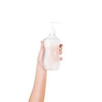 Female hand holding cream bottle of lotion isolated. Girl give cosmetic products on white background photo