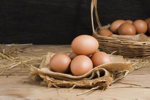 Fresh organic chicken eggs from the farm on a rustic wooden table. photo