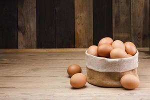 Fresh organic chicken eggs from the farm on a rustic wooden table. photo