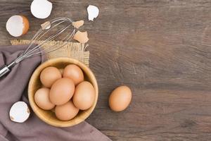 Chicken eggs in a wooden bowl Farm fresh organic eggs laid on a rustic wood photo