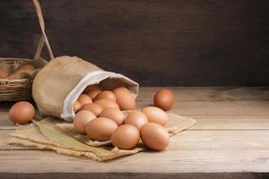 Fresh organic chicken eggs from the farm on a rustic wooden table. photo