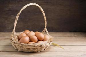 Fresh organic chicken eggs from the farm on a rustic wooden table. photo