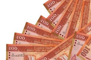 100 Sri Lankan rupees bills lies in different order isolated on white. Local banking or money making concept photo