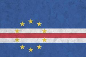 Cabo verde flag depicted in bright paint colors on old relief plastering wall. Textured banner on rough background photo