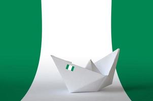 Nigeria flag depicted on paper origami ship closeup. Handmade arts concept photo