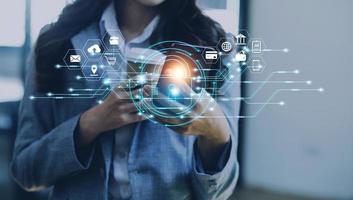 Cybersecurity and privacy concepts to protect data. Lock icon and internet network security technology. Businessman protecting personal data on smart phone with virtual screen interfaces. photo