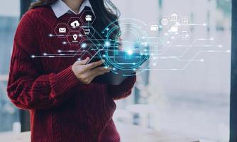 Cybersecurity and privacy concepts to protect data. Lock icon and internet network security technology. Businessman protecting personal data on smart phone with virtual screen interfaces. photo