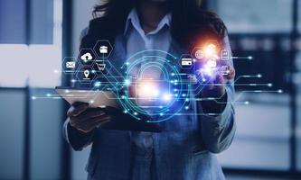 Cybersecurity and privacy concepts to protect data. Lock icon and internet network security technology. Businessman protecting personal data on smart phone with virtual screen interfaces. photo