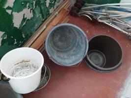 Plastic buckets lie on the balcony of the house photo