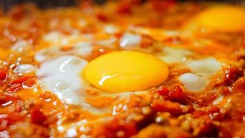 Fried eggs in Georgian cuisine, chirbuli. Eggs with tomatoes steaming in the pan video