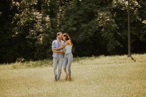 Happy young couple in love at the grass field photo