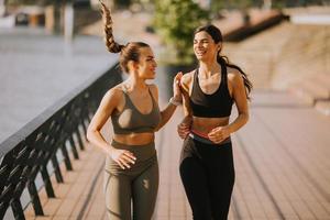 Young woman taking running exercise by the river promenade photo