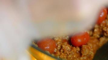 Mix the ingredients for the chorizo and the preserved tomatoes with a wooden spoon. Macro shooting video