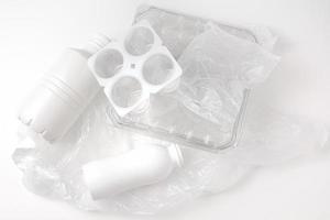 Heap of plastic garbage, trash on white background. Concept of Recycling plastic and ecology. Flat lay, top view. photo