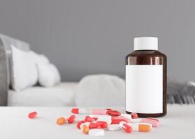 Pills and blank bottle on table at home. Medicines, tablets. Sick to be. Stay in bed. Medical bottle mock up. Illness, disease, health, healthcare concept. Copy space for your text, logo. 3d render. photo