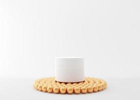 White and blank, unbranded cosmetic cream jar standing on podium with small golden balls. Skin care product presentation on white background. Luxury mockup. Skincare, beauty and spa. 3D rendering. photo