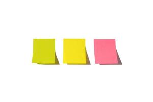 Three sheets of note papers, ready for your message. Sticky notes isolated on white background. Pink, green and yellow colors. Copy space. photo