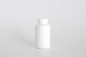 Pills bottle. White medical container for drugs, diet, nutritional supplements. White plastic jar for pills. Packaging mockup template. Free space, copy space. photo