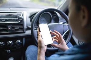 The driver uses the phone while driving. Isolated screen for mockup. Car navigation display in background. photo
