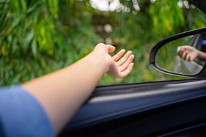 Happy young woman enjoys a leisurely vacation in the car. photo