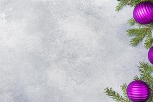 Christmas scenery, toys and branches fir on grey background. New Year concept Copy space photo