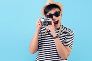 Happy tourists taking pictures on a blue background in the studio photo