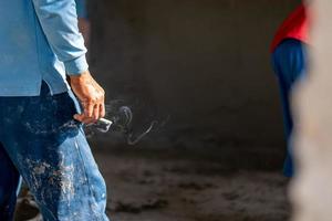 Workers smoke on the construction site. Health care concept. photo