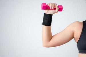 Women wearing black exercise clothes and lifting dumbbells to train arm muscles at home. Concepts of exercise and muscle training. photo