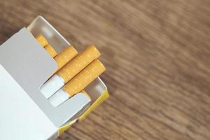 peel it off Cigarette pack prepare smoking. Packing line up put on the wooden table. photo filters Natural light.