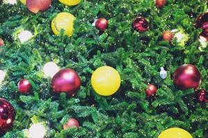 Closeup of bauble colorful variety hanging from a decorated christmas tree on blurred of lights with decorated tree, sparkling and bokeh background. copy space for your text. Christmas Tree Decoration photo
