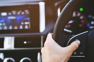 close up Modern black steering wheel with multifunction buttons Integrated stereo controls pushes the for quick control technology in the car. photo