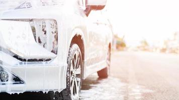 Outdoor car wash with foam soap. photo