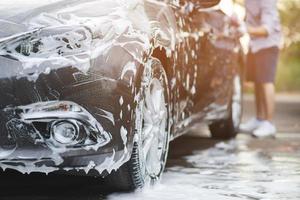 Outdoor car wash with foam soap. photo