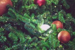 Closeup of bauble colorful variety hanging from a decorated christmas tree on blurred of lights with decorated tree, sparkling and bokeh background. copy space for your text. Christmas Tree Decoration photo