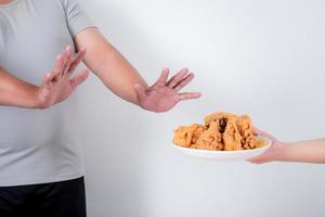 Fat people reject fried chicken on a white background. photo