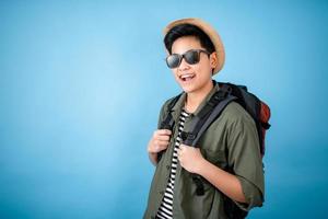 Asian backpackers are smiling and happy on the blue background in the studio. photo