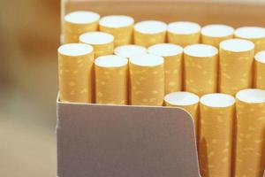 peel it off Cigarette pack prepare smoking. Packing line up put on the wooden table. photo filters Natural light.