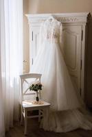 dress up the bride in a wedding dress with corset and lacing photo