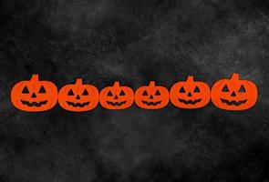 Top view on felted pumpkins on dark concrete background with place for text. Halloween concept photo