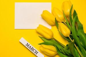 Women's day banner with yellow tulips and place for text photo