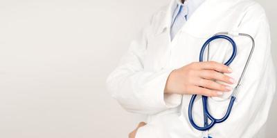 Healthcare concept panoramic banner.Unrecognizable doctor in white lab coat holding stethoscope in hands photo