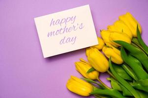 Spring background with yellow tulips and empty card for text. Happy mother's day photo