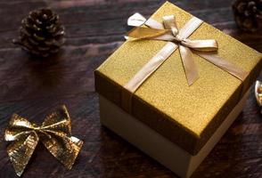 Closeup of shiny little golden box with present for christmas ir new year. 2023