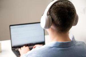 Asian man programming or online shopping using laptop.Selective focus photo