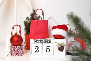Christmas concept, festive snow globe,ornaments,gift bags,lights and other decorations on December calendar.Copy space banner photo