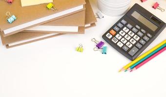 Back to school flatlay with books,calculator,pencils and other supplies on white bacground. Banner with place for text photo